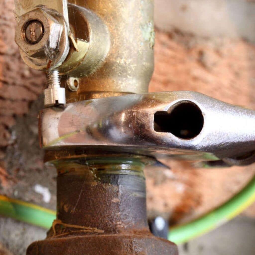 gas line plumber using a grip to tighten a pipe