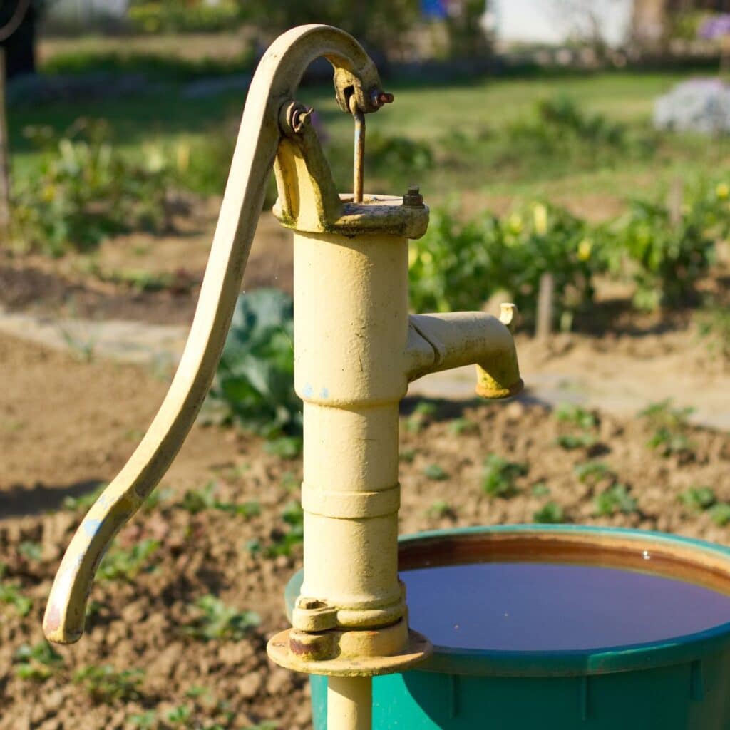 close up of a well pump after it has pumped water for a garden