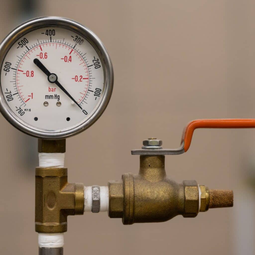 Close-up of a pressure regulator valve with a pressure gauge attached