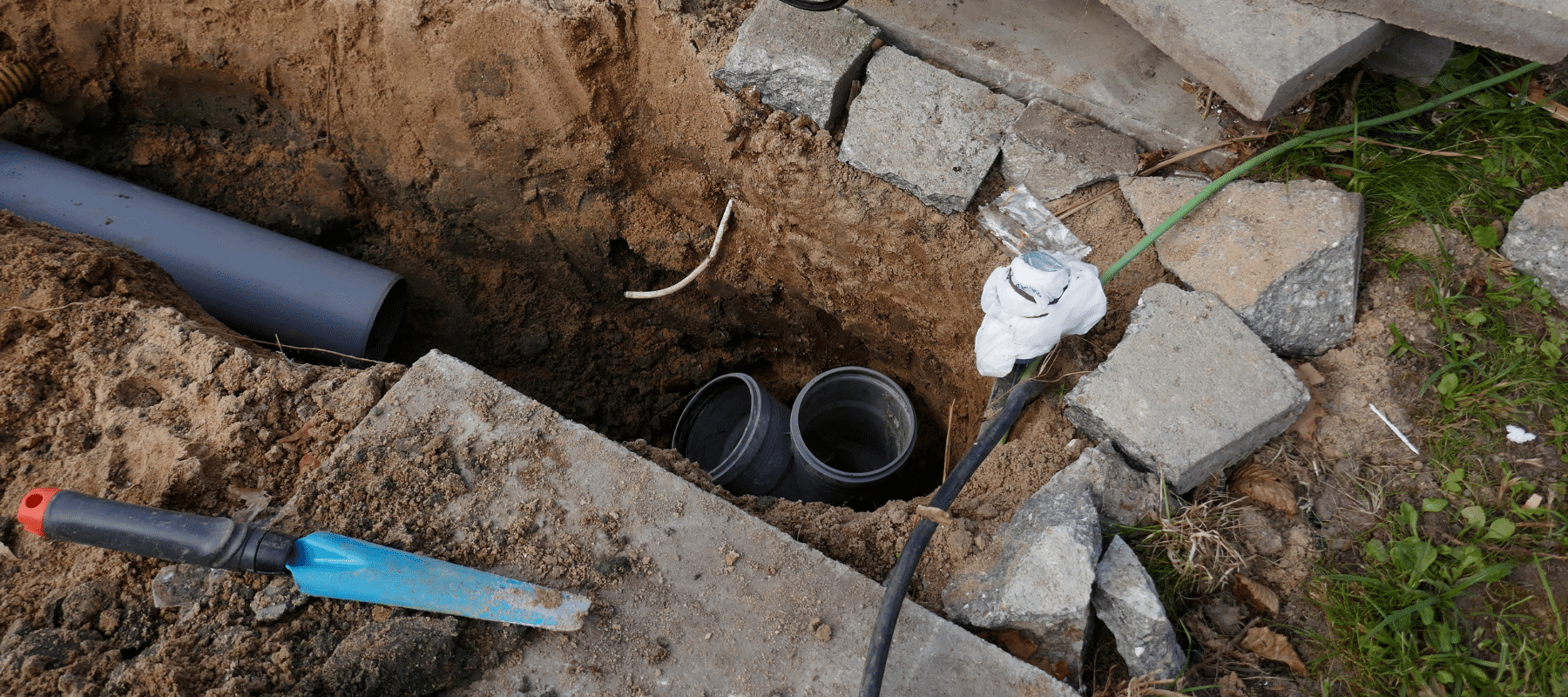 closeup of a plumber working on a sewer line repair