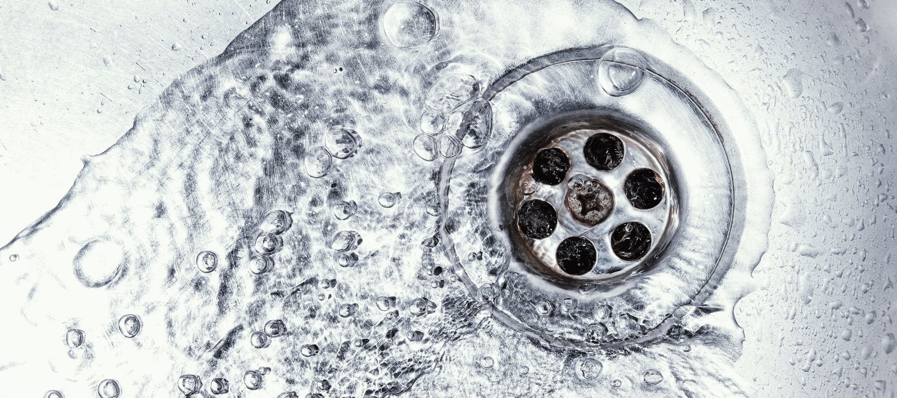 closeup of a drain with water flowing down it