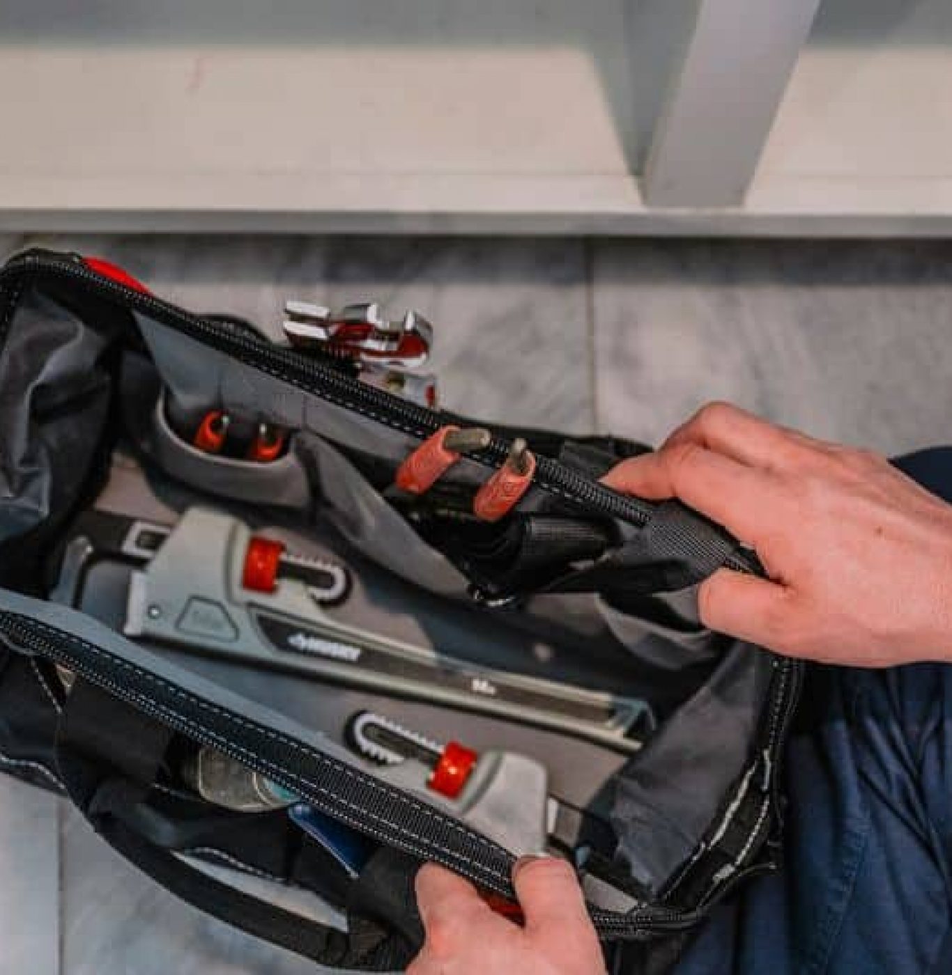 Service Squad Plumbing expert using high-tech equipment for drain cleaning in a Burleson home