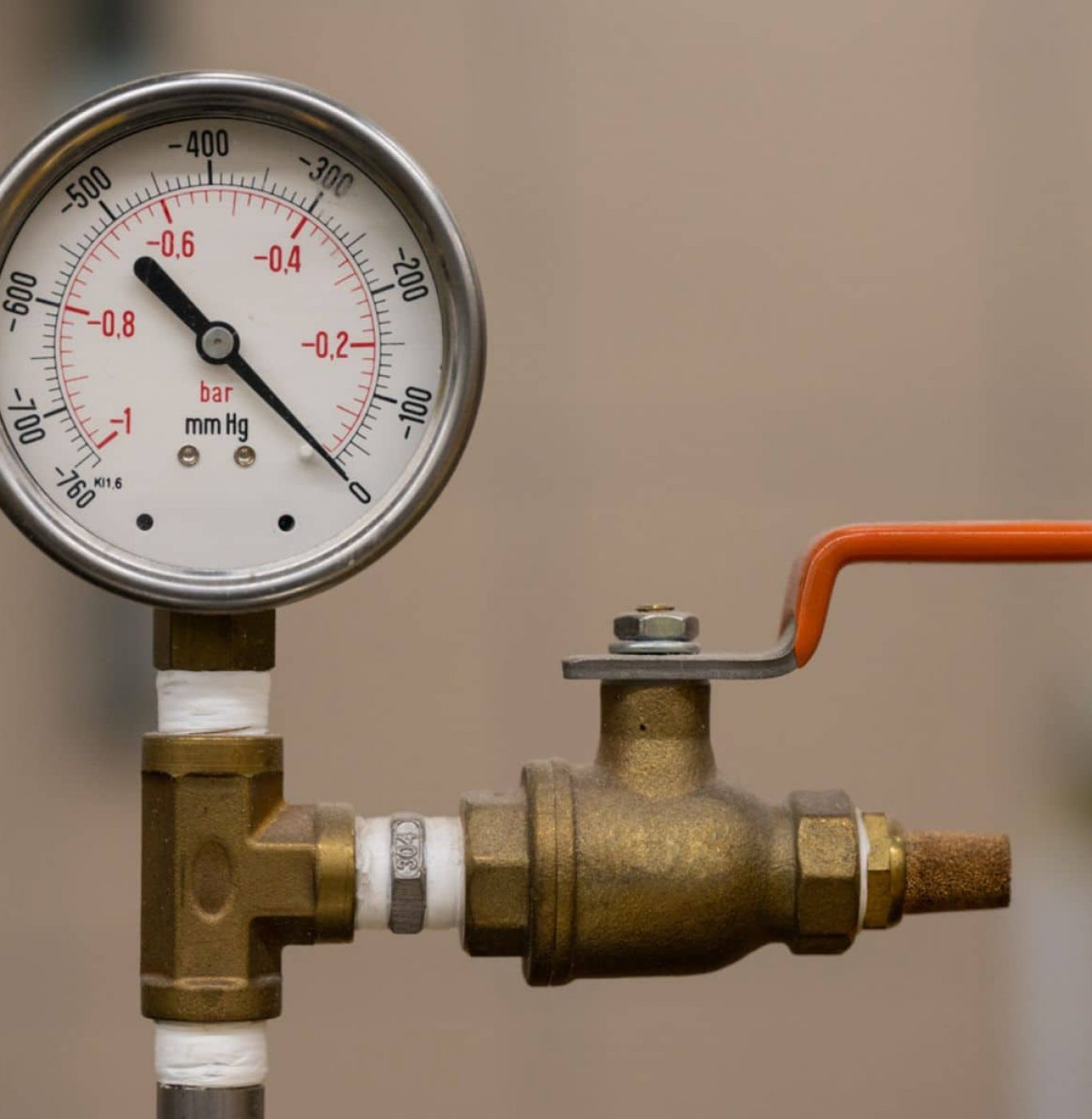 Close-up of a pressure regulator valve with a pressure gauge attached