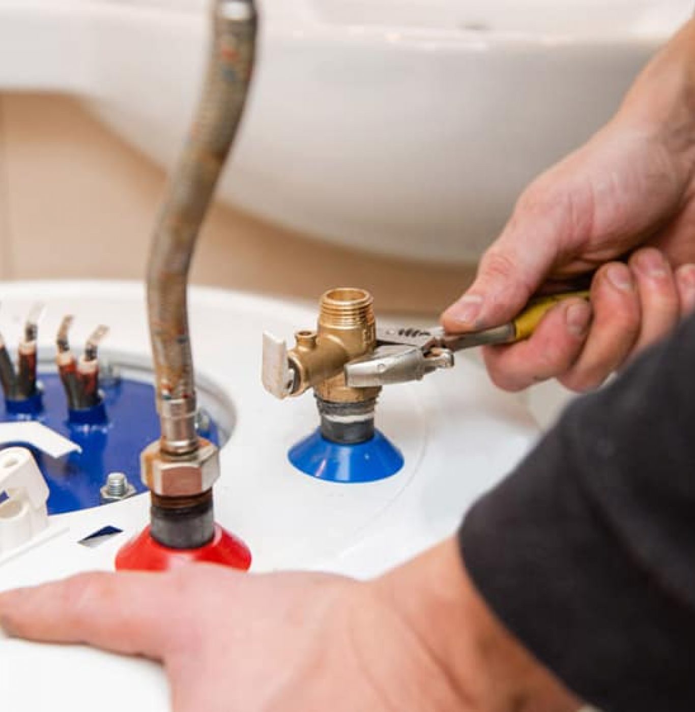 Service Squad Plumbing water heater repair technician inspecting tank